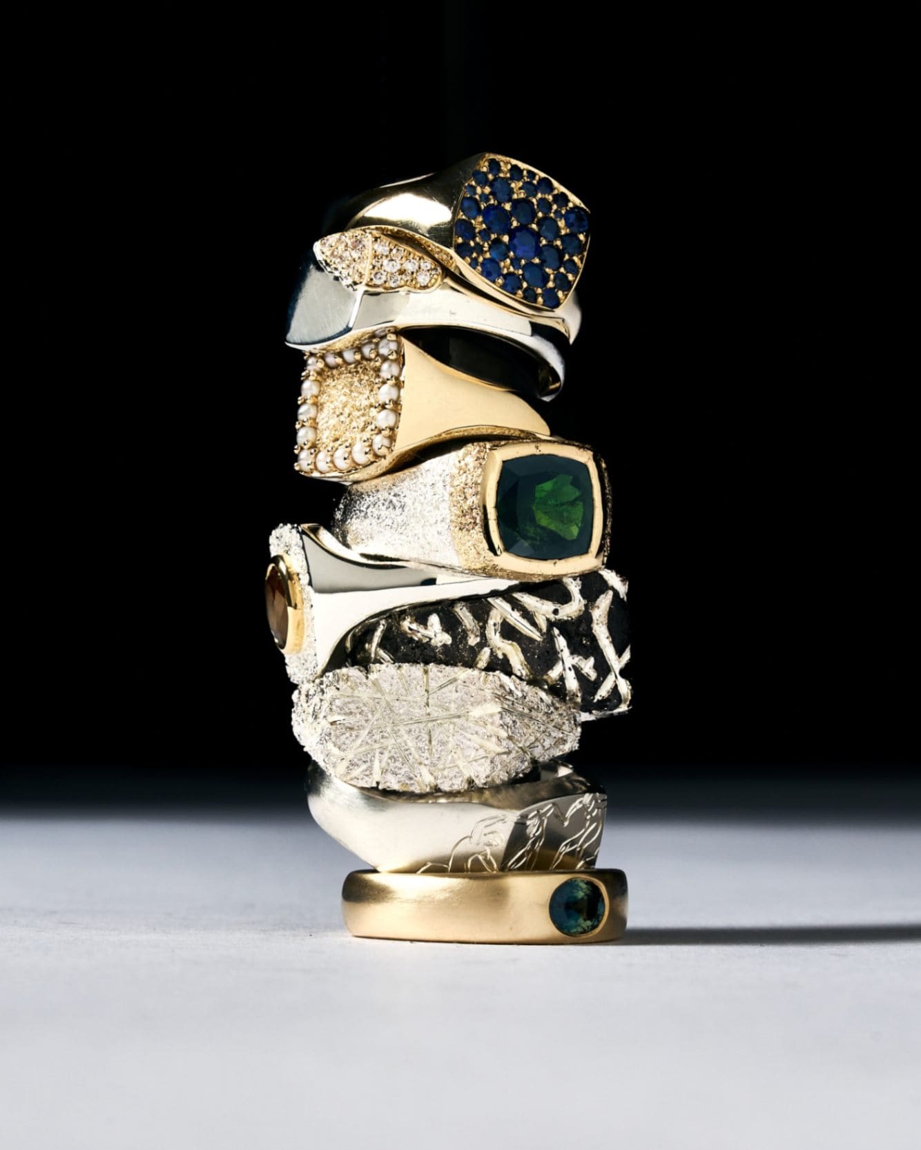 Stack of various one of a kind rings made in silver gold and natural gemstones.